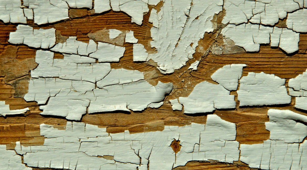 Close up of chipped paint on wood.