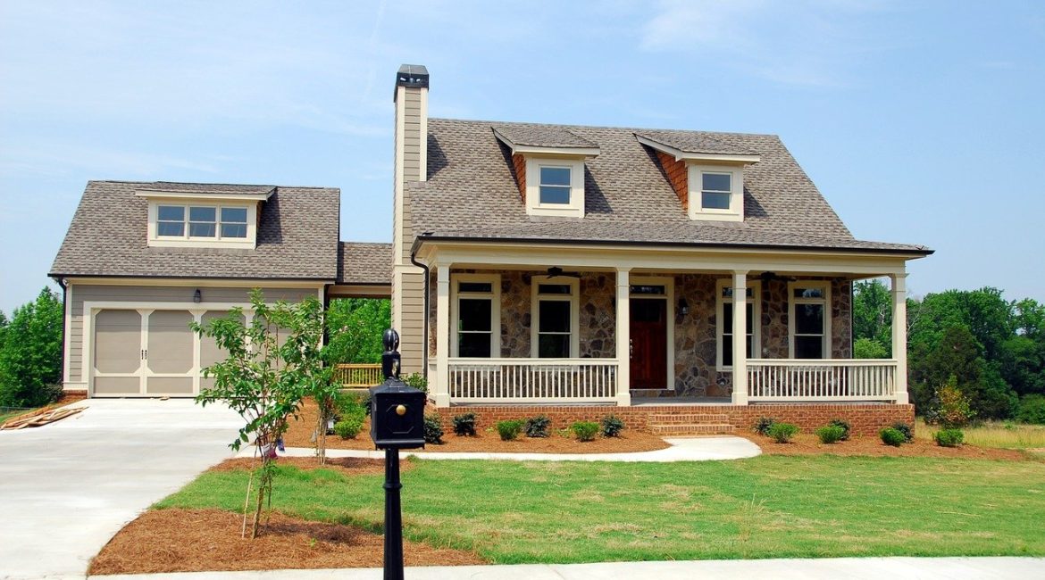 Exterior shot of a luxury home with front lawn and garage