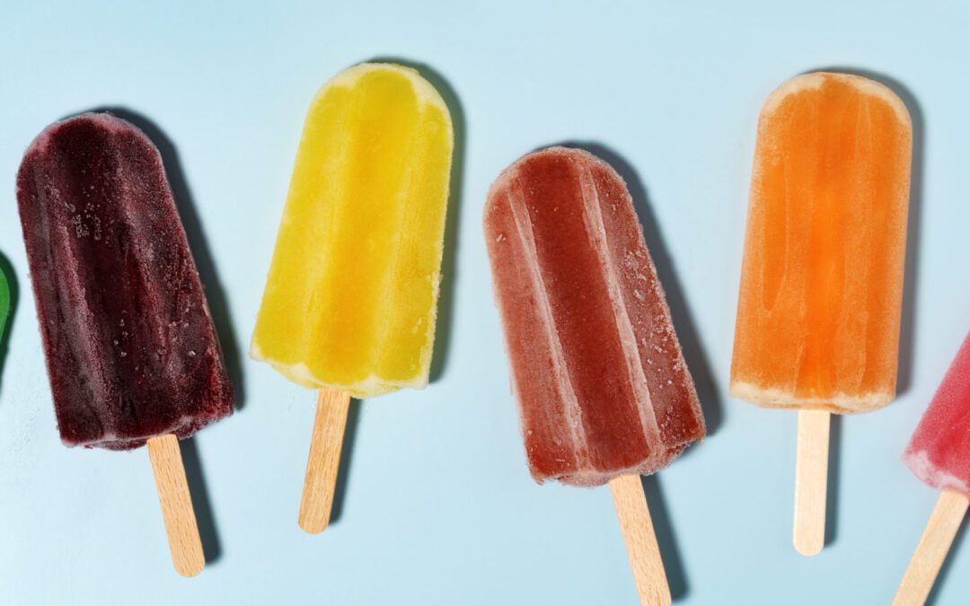 Colorful popsicles pop against a light blue background.